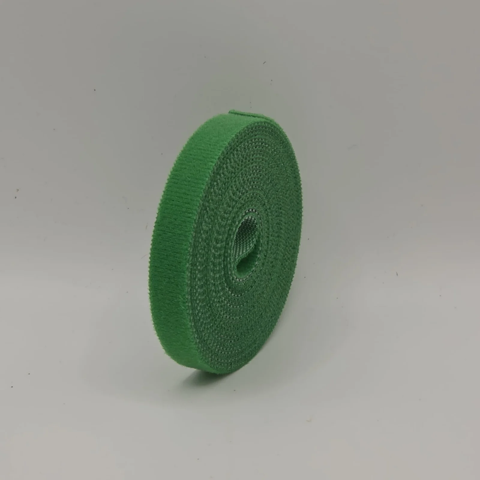 Green floral tape roll displayed against white background, showing woven mesh texture.