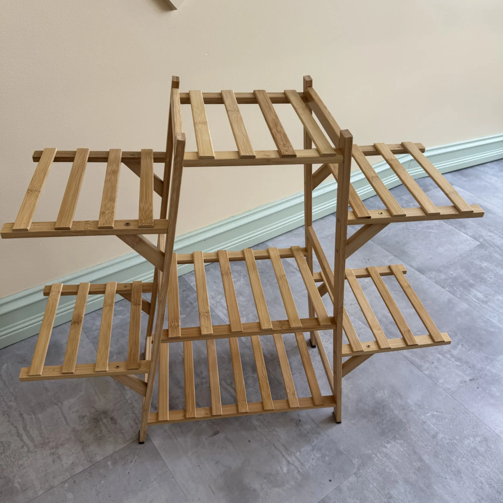 Bamboo plant stand with multiple wooden shelves for displaying potted plants