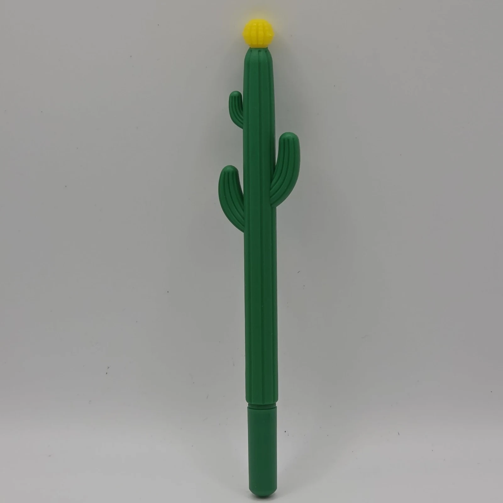 Cactus Pen with green barrel and yellow flower top against white background.