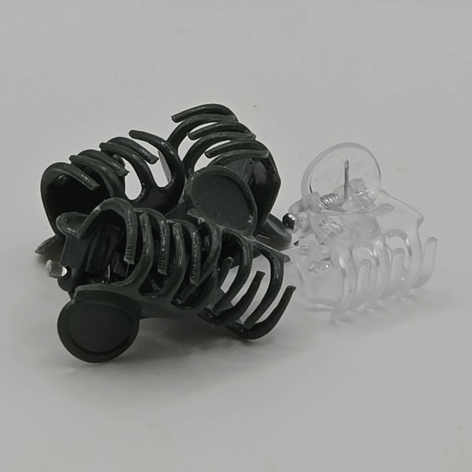 Plant Clips in black and clear plastic, organizing and supporting stems.
