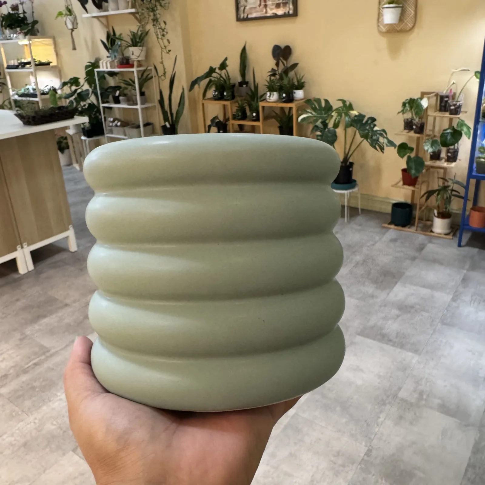 4.5" Blue and Purple Ribbed Ceramic Pot with horizontal grooves held in hand