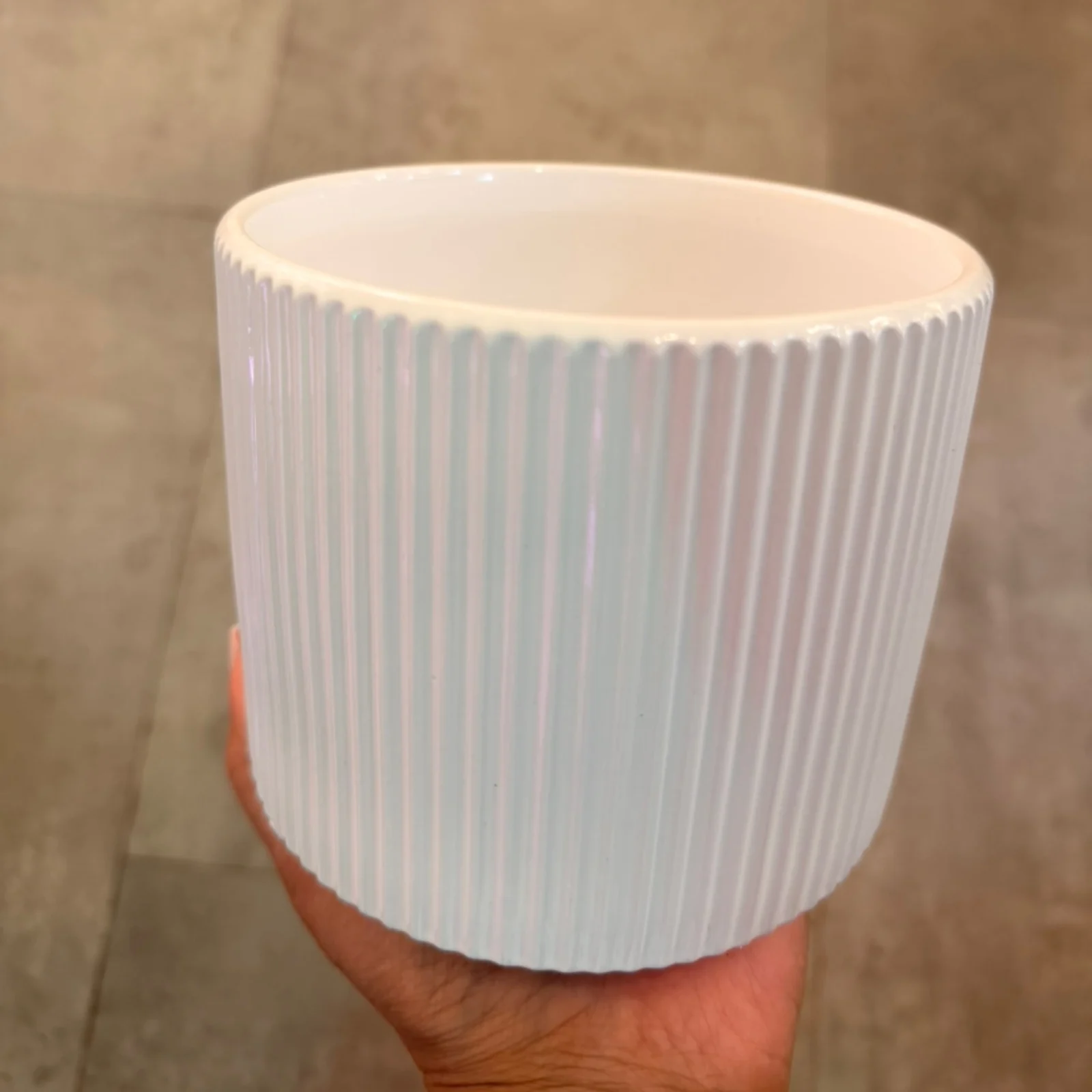 4" Siena Pot Round White ceramic ridged plant pot held in hand, empty.