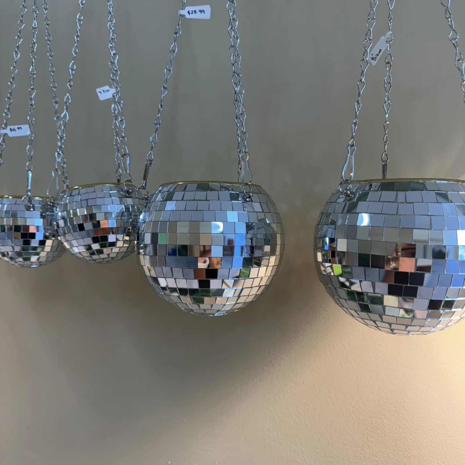 Disco Hanging Planter with mirrored disco ball pot suspended by silver chain.