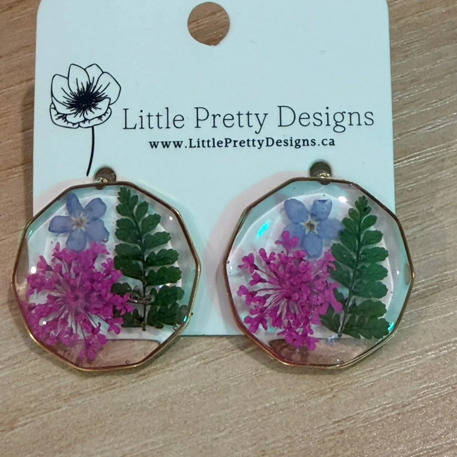Little Pretty Designs Earrings with pressed purple flowers and green leaves in resin.