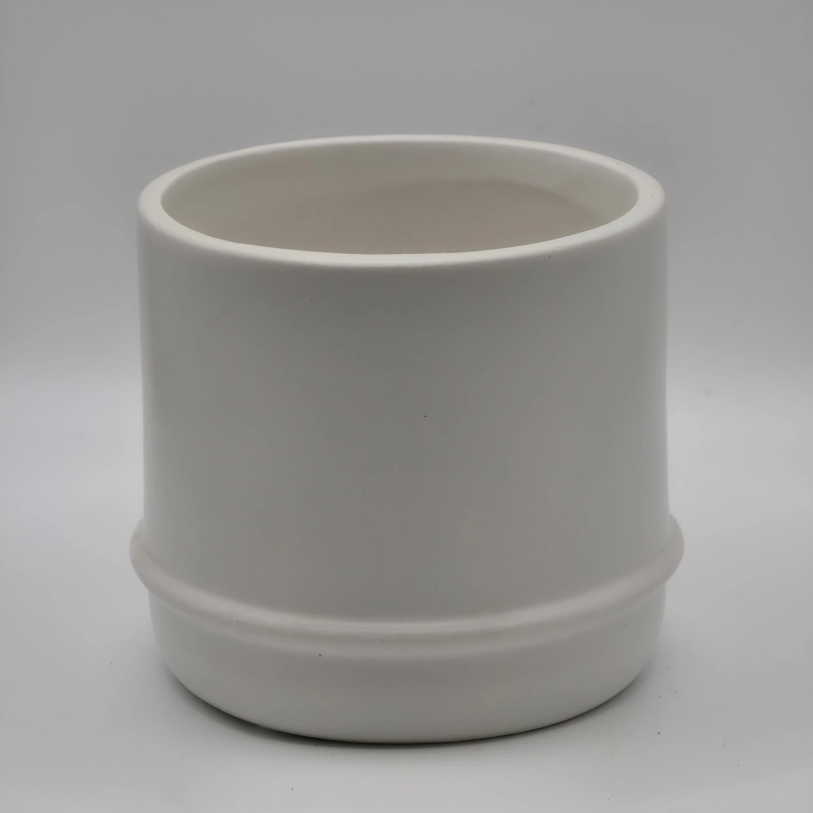 Small Elio Pot 4" white ceramic cylindrical planter with drainage design.