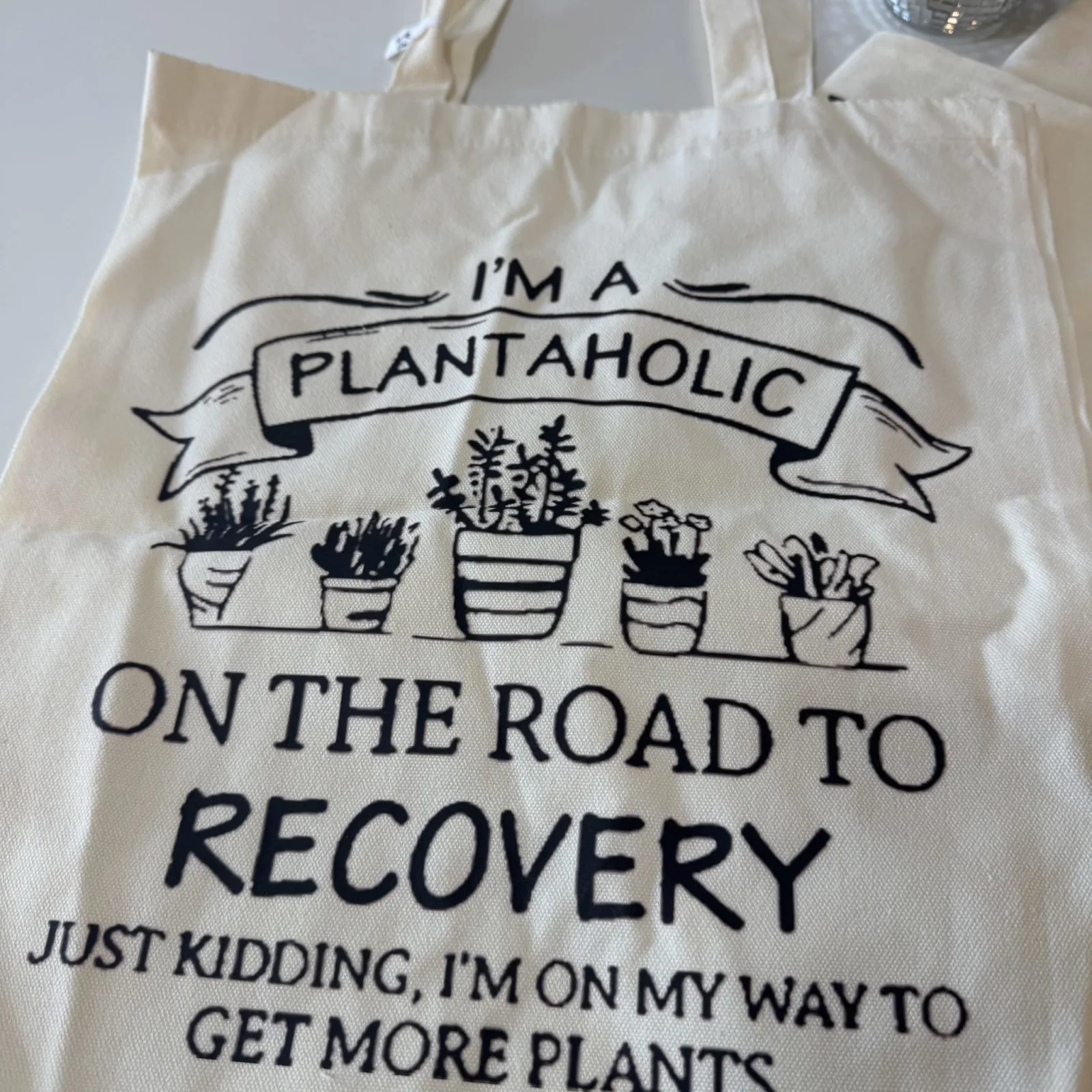 Plant Tote bag with humorous text about being a plantaholic and getting more plants.