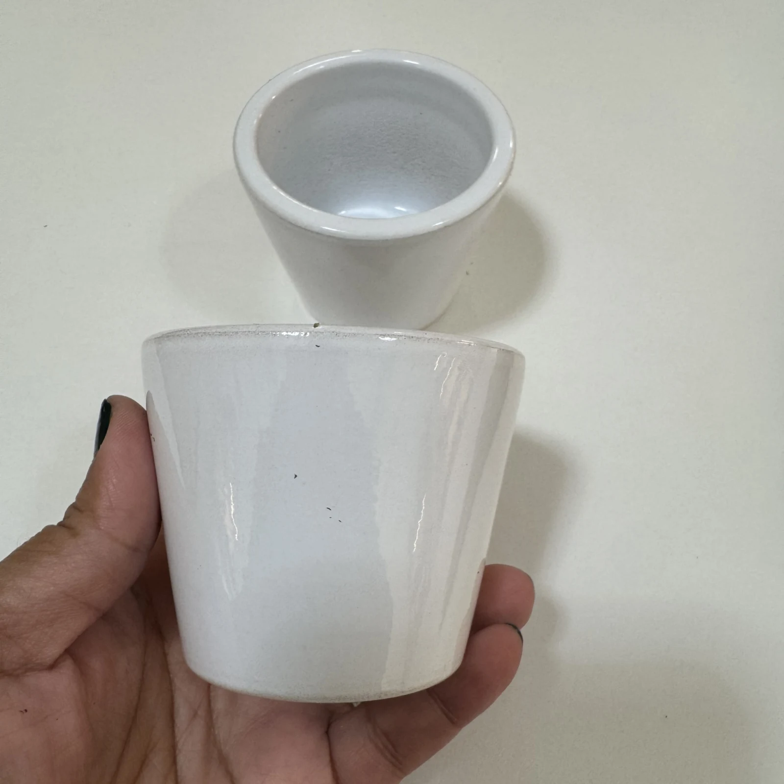 2.5" Karla White Ceramic Pot with removable lid held in hand against white background.